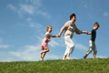 Children with grandmother holding hands run up