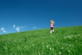 Preschool girl rise on hill