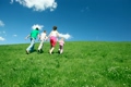 Happy family holding hands up hill