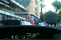 Driving inside car Toyota Prius with hybrid engine through narrow streets in city