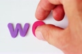 Hand put letters until they are form word WORD