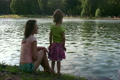 mother with girl on pond