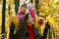 woman with leaves and girls in park
