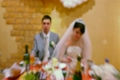 groom and bride sitting at wedding table