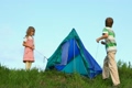 boy and his kid sister tenting outdoors