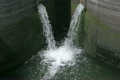 water streams run into stock in some grey concrete building