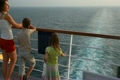 mother with son and girl stands on deck of ship