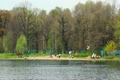 people have a rest on coast of spring park near lake
